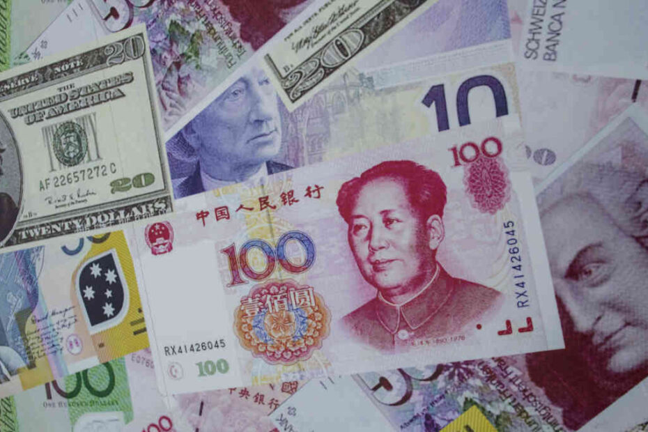 notas de yuan sao dispostas junto de notas de dolar e euro